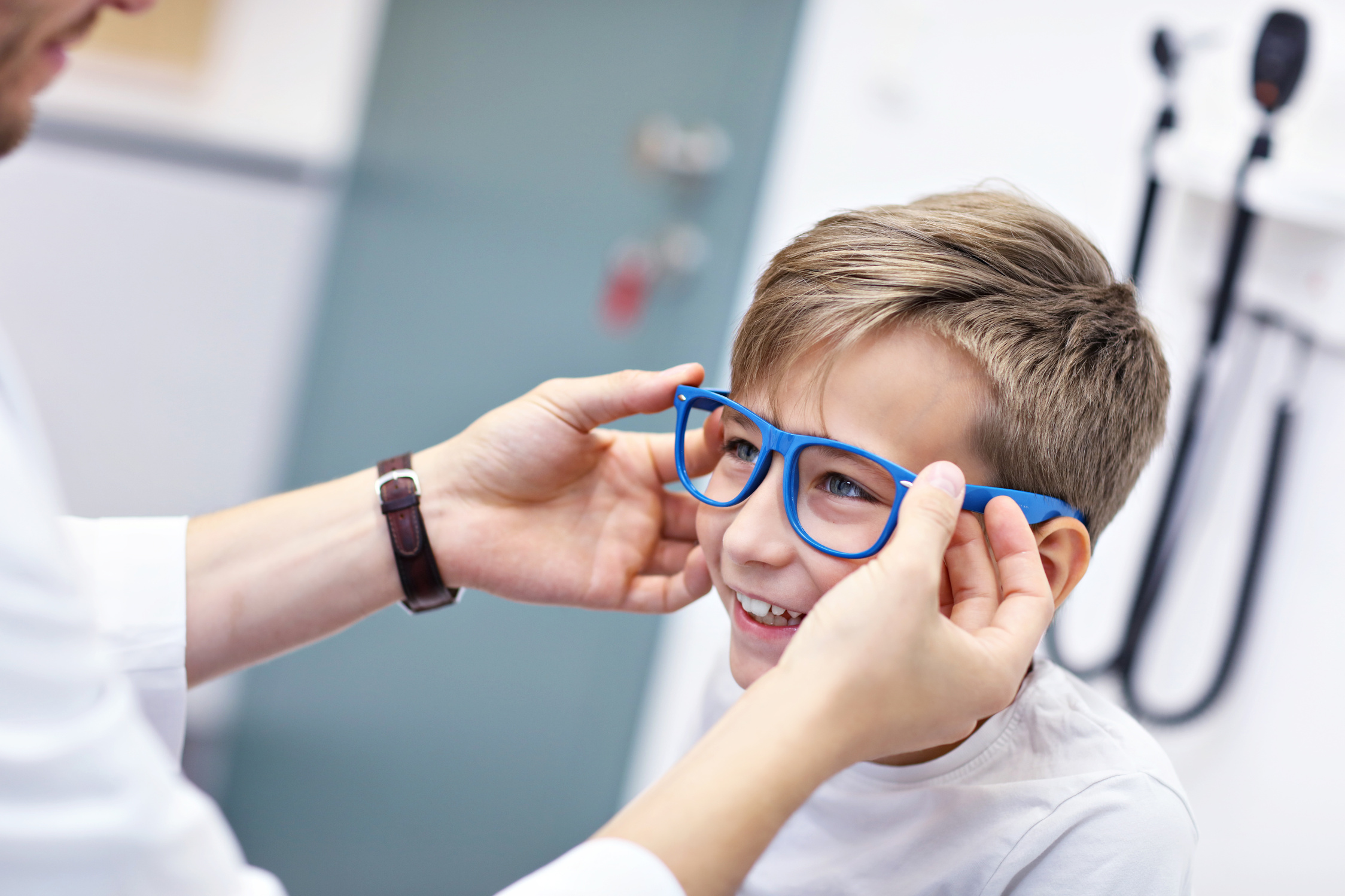 Child Optometry Male Optometrist Optician Doctor Examines Eyesight of Little Boy